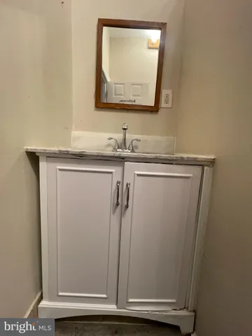a bathroom with a sink a mirror and a vanity