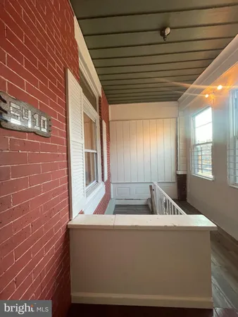 a view of balcony with a table and chairs