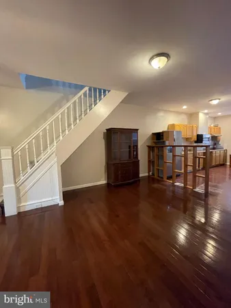 a view of a livingroom with furniture and hardwood floor