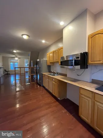 a large kitchen with a large counter top appliances and cabinets