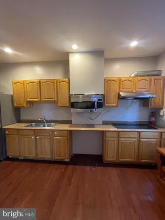 a kitchen with stainless steel appliances granite countertop a sink and cabinets