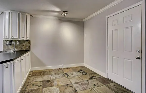 a view of an empty room and staircase