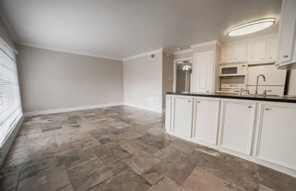 a view of kitchen with granite countertop cabinets and sink