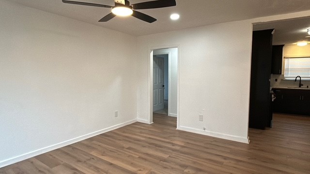 6330 Cobalt Street Houston, TX 77016 - Photo 12 of 29 an empty room with wooden floor cabinet and windows