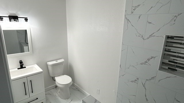 6330 Cobalt Street Houston, TX 77016 - Photo 15 of 29 a bathroom with a toilet sink and shower