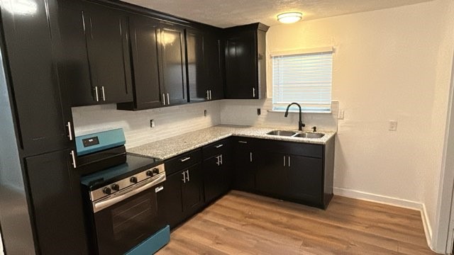 6330 Cobalt Street Houston, TX 77016 - Photo 9 of 29 a kitchen with a sink and a stove top oven