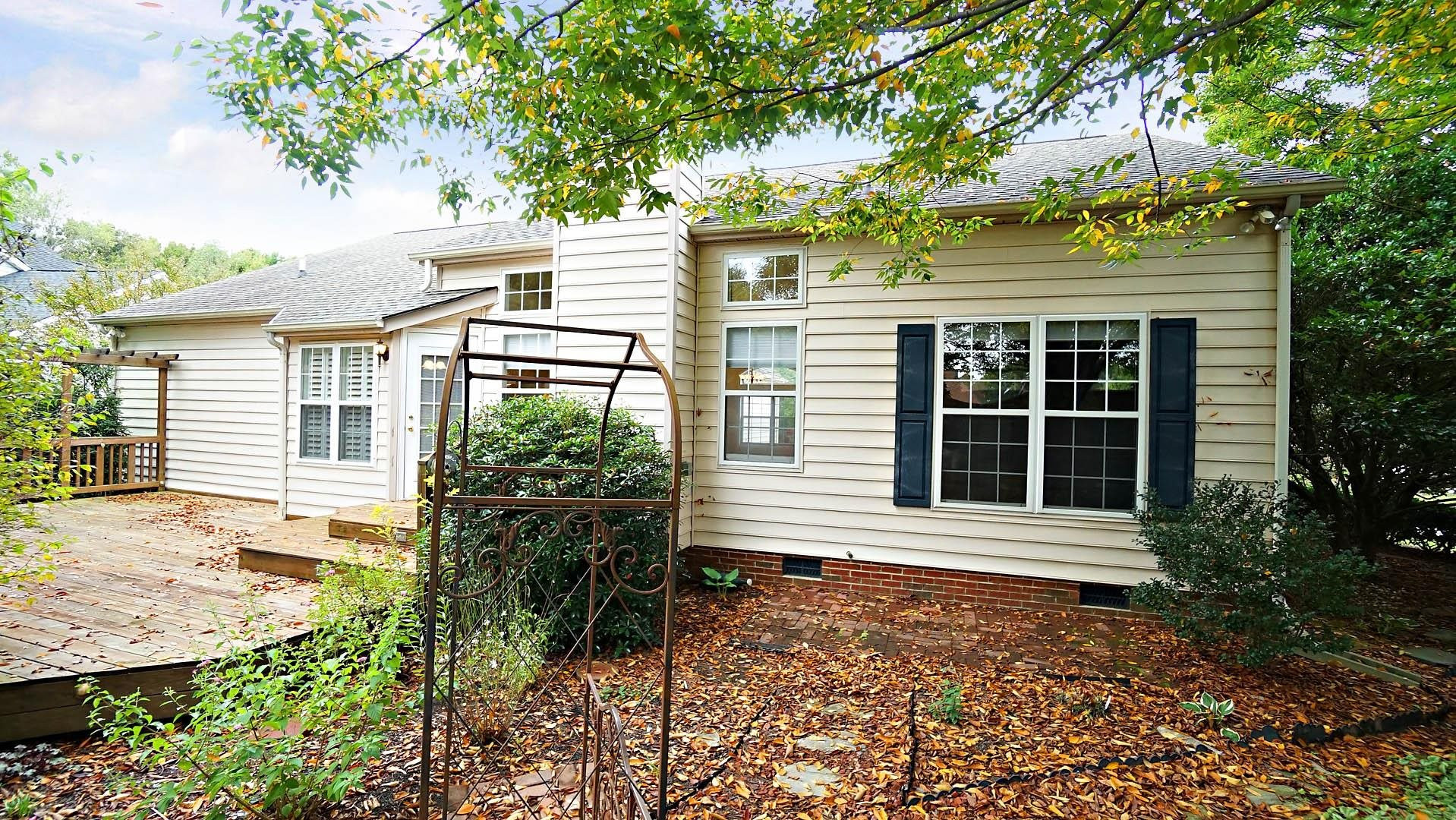 8316 Trumpetor Way Raleigh, NC 27613 - Photo 23 of 26 A small brick patio sets off to the right of the deck. Patio/Deck