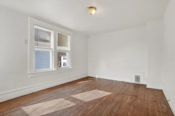 an empty room with windows and closet