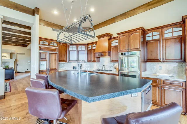 a dining table with chairs and chandelier