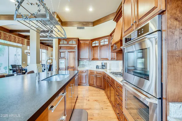 a large kitchen with stainless steel appliances granite countertop a lot of counter space