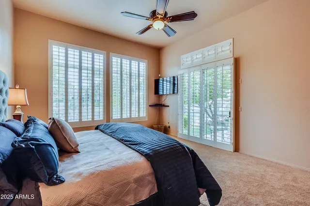 a bedroom with a large bed and a chandelier