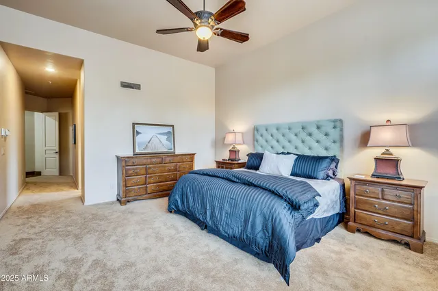 a bedroom with a bed and a chandelier