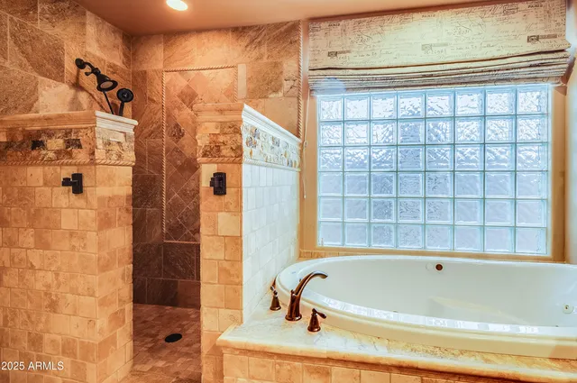 a bathroom with a bathtub and shower
