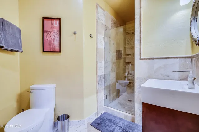 a bathroom with a sink a toilet and shower curtain