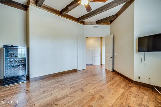 a view of an empty room with wooden floor