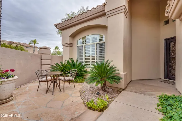 a view of house with backyard and outdoor seating