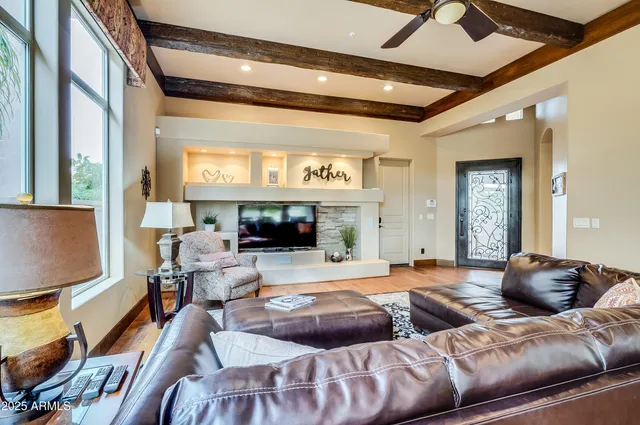 a living room with furniture a fireplace and a flat screen tv
