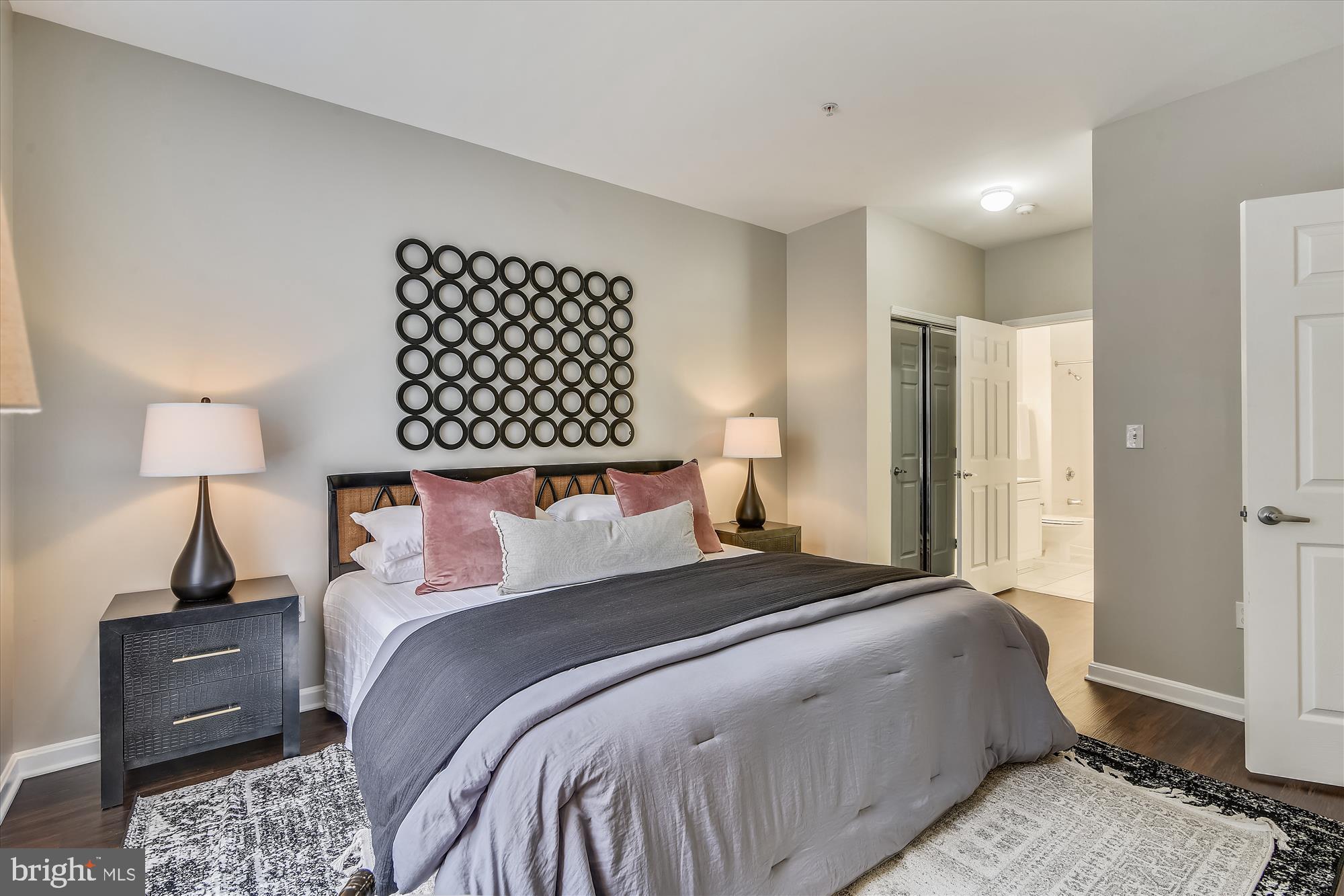 2726 Gallows Road, Unit 113 Vienna, VA 22180 - Photo 12 of 29 a bedroom with a bed and a lamp