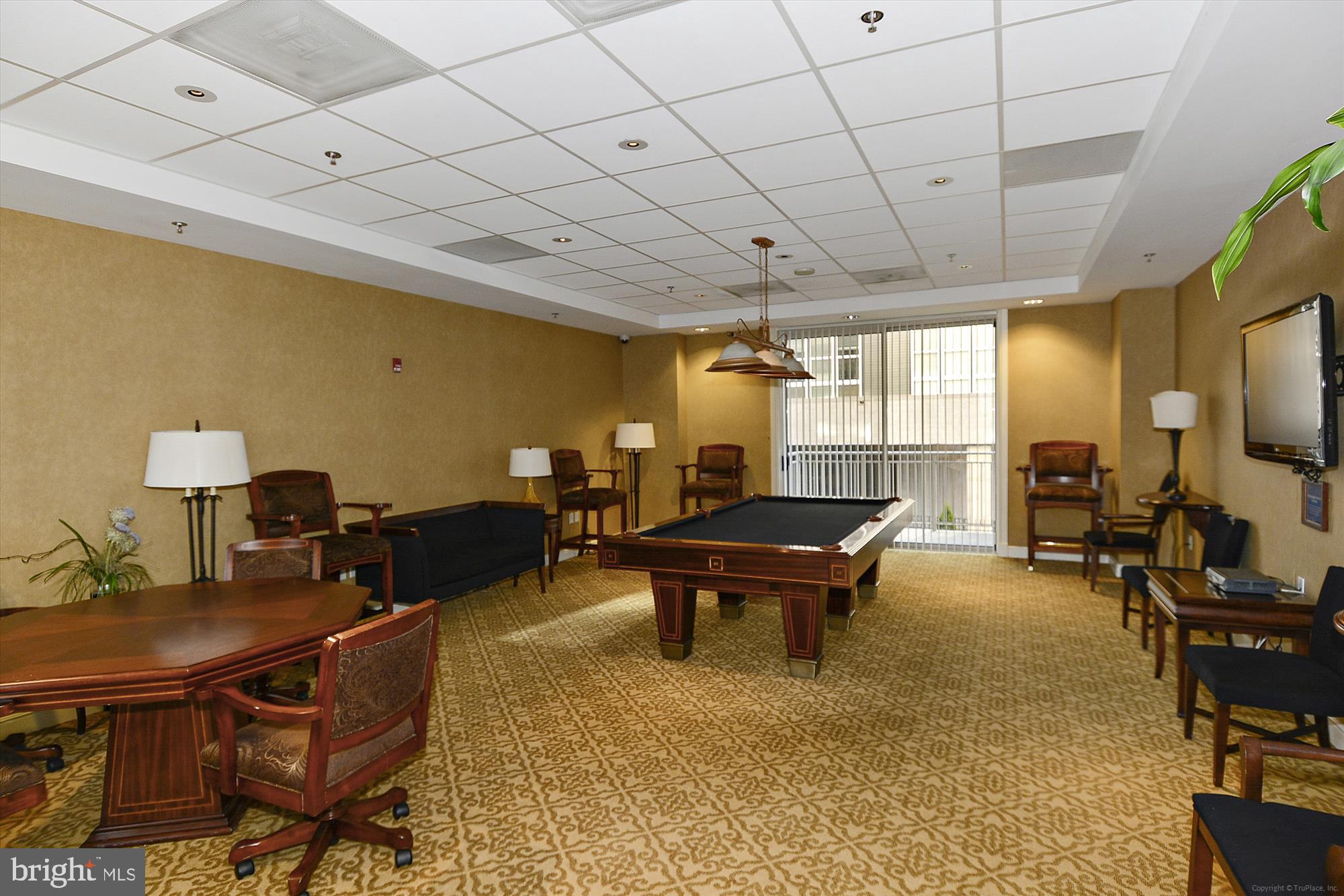 2726 Gallows Road, Unit 113 Vienna, VA 22180 - Photo 26 of 29 a living room with furniture a flat screen tv and a table