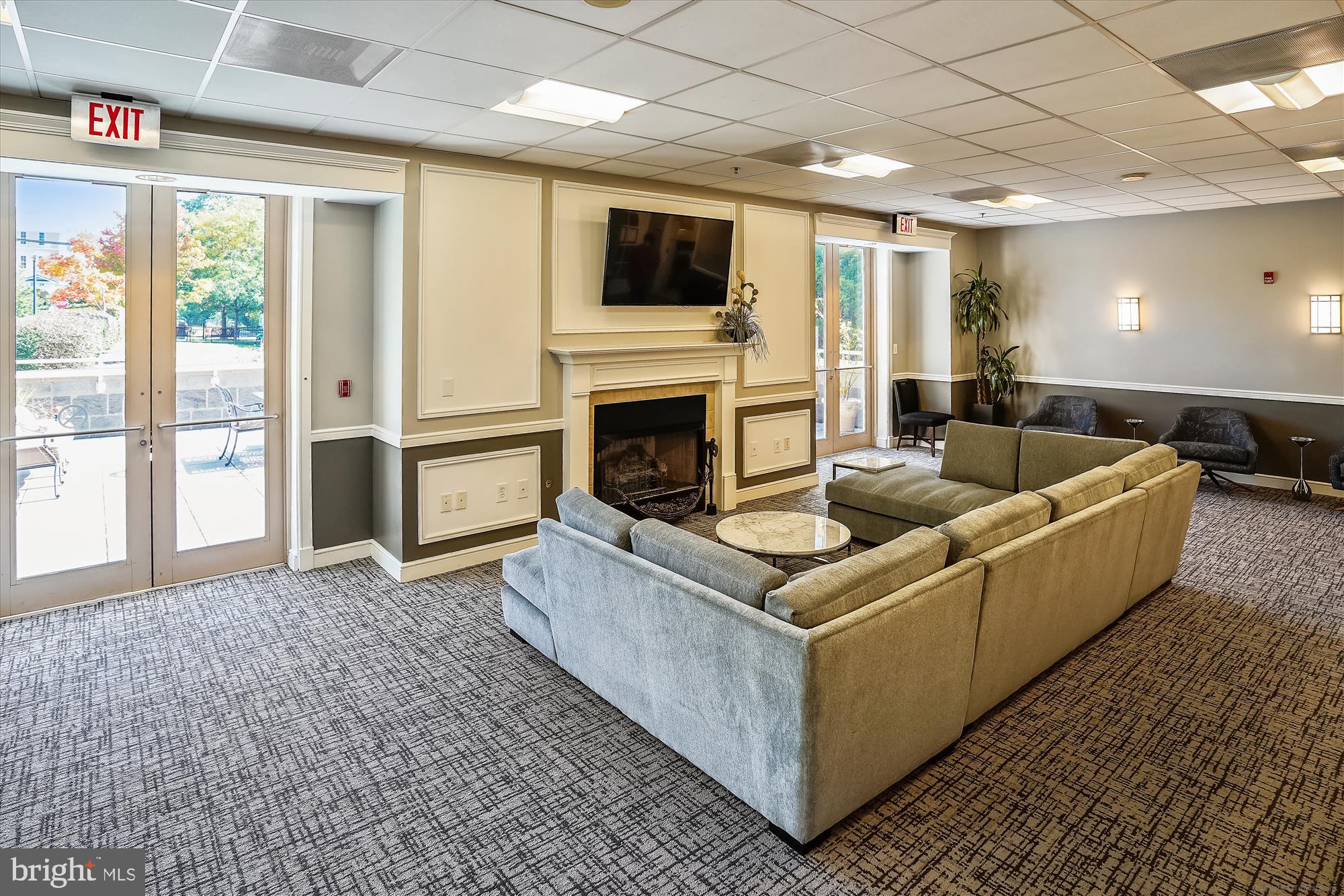 2726 Gallows Road, Unit 113 Vienna, VA 22180 - Photo 27 of 29 a living room with furniture a flat screen tv and a fireplace