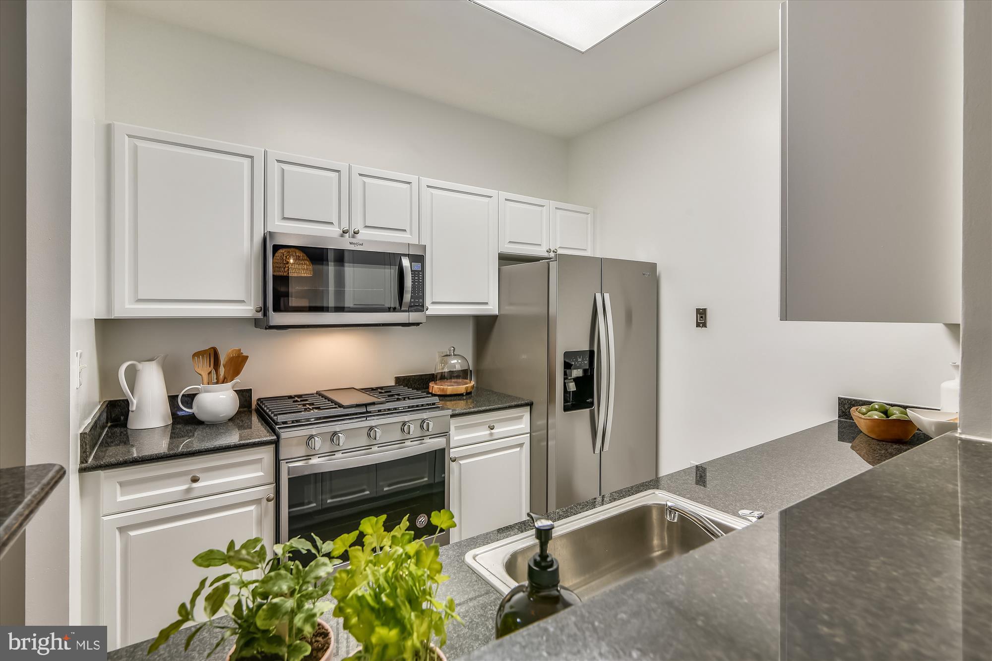2726 Gallows Road, Unit 113 Vienna, VA 22180 - Photo 5 of 29 a kitchen with stainless steel appliances granite countertop a refrigerator sink and stove