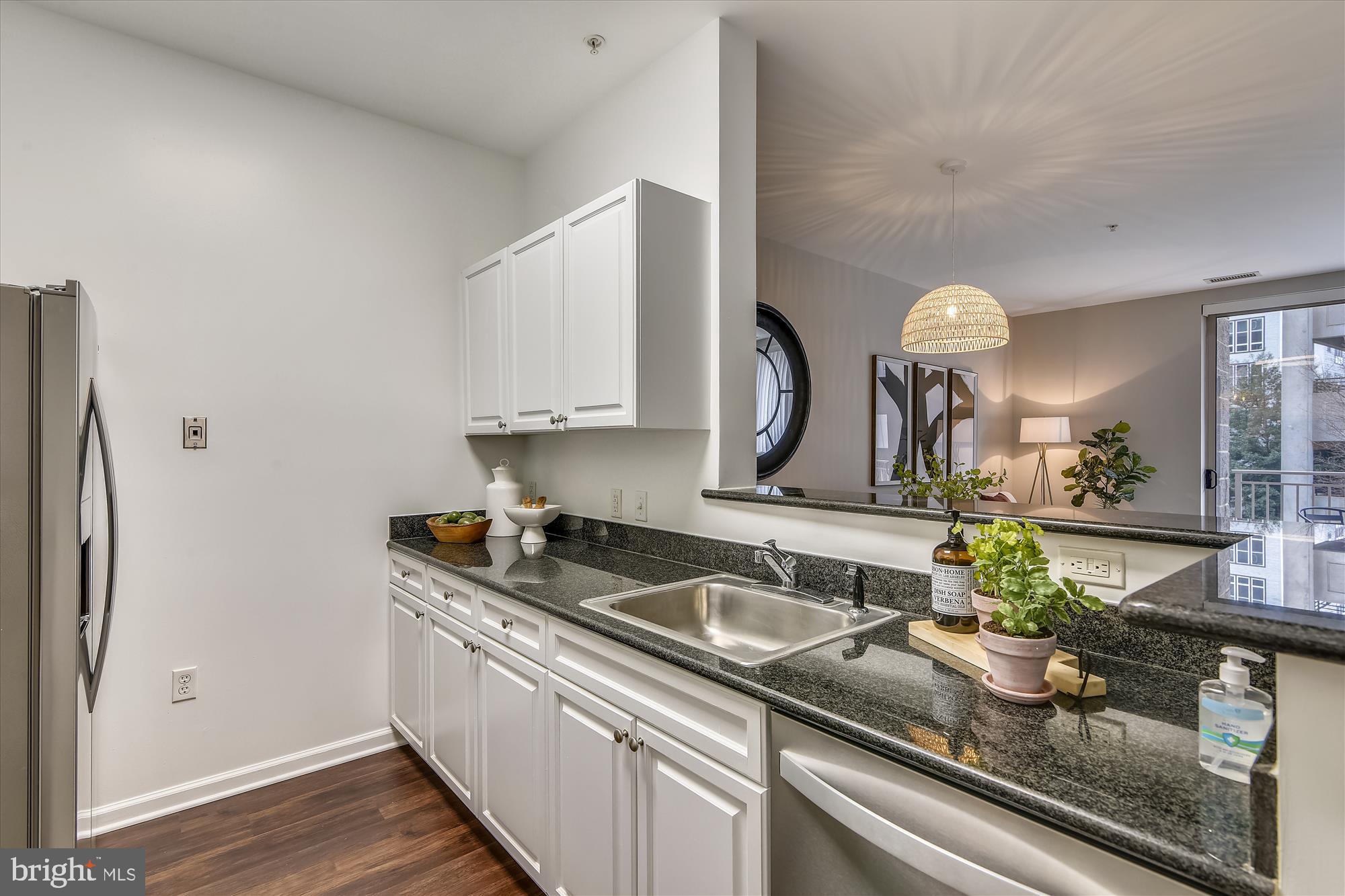 2726 Gallows Road, Unit 113 Vienna, VA 22180 - Photo 28 of 29 a kitchen with stainless steel appliances granite countertop a sink and a granite counter tops
