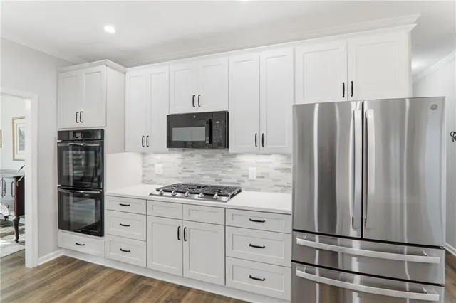 a living room with furniture kitchen view and a chandelier