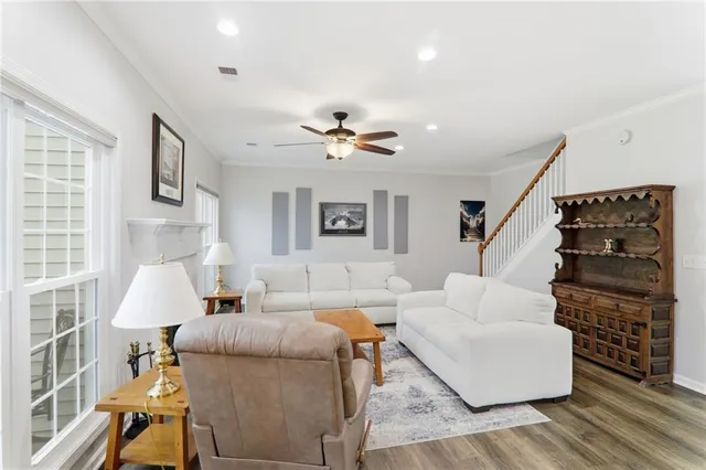 a dining room with furniture a chandelier and wooden floor