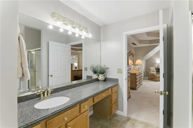 a bathroom with a double vanity sink mirror and shower