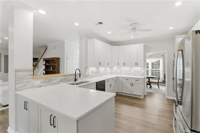 a kitchen with a sink stainless steel appliances and cabinets