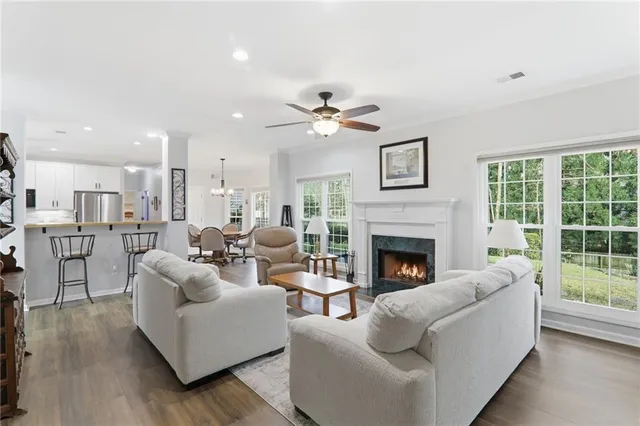 a living room with furniture fireplace and window