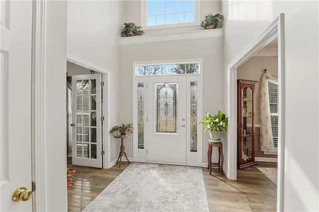 a view of a hallway with wooden floor and a living room