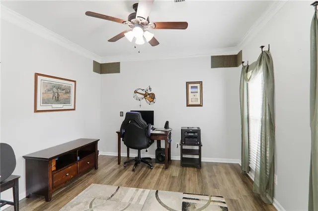 a living room with furniture a bookshelf and a window