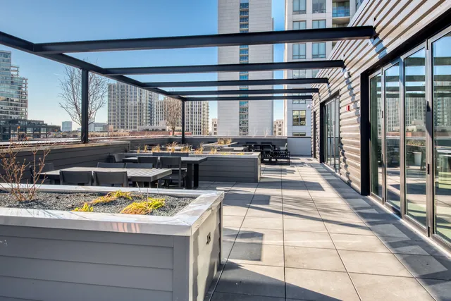 a view of kitchen with stainless steel appliances kitchen island granite countertop a sink and counter top