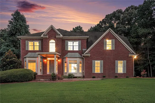 a front view of a house with a yard