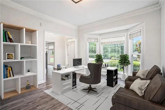 a view of a livingroom with workspace and a window