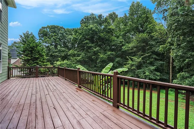 a view of balcony with wooden floor and fence