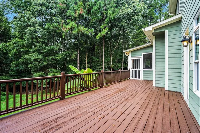 a view of backyard with deck and wooden floor
