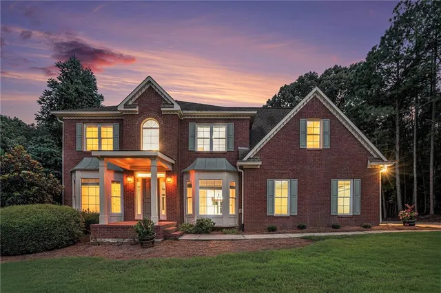a front view of a house with a yard