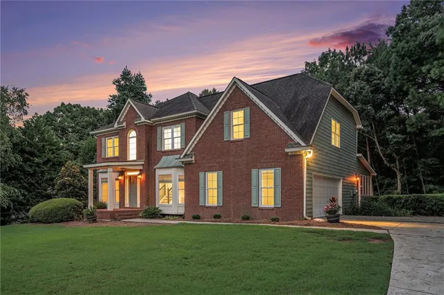 a front view of a house with a garden