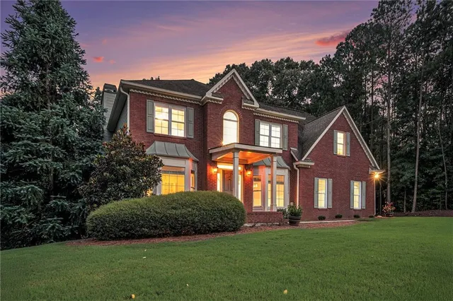 a front view of a house with a yard