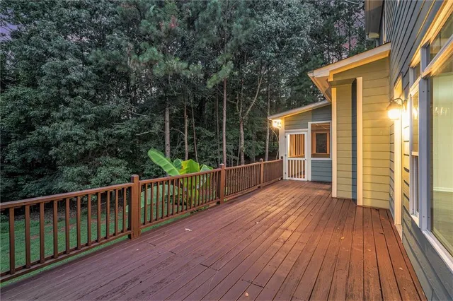 a view of backyard with deck and wooden floor