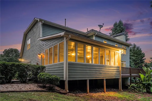 a view of house with backyard and swimming pool