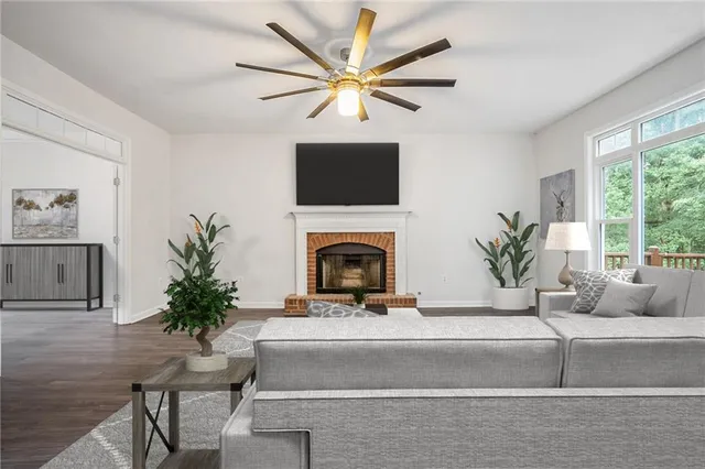 a living room with furniture a fireplace and a large window
