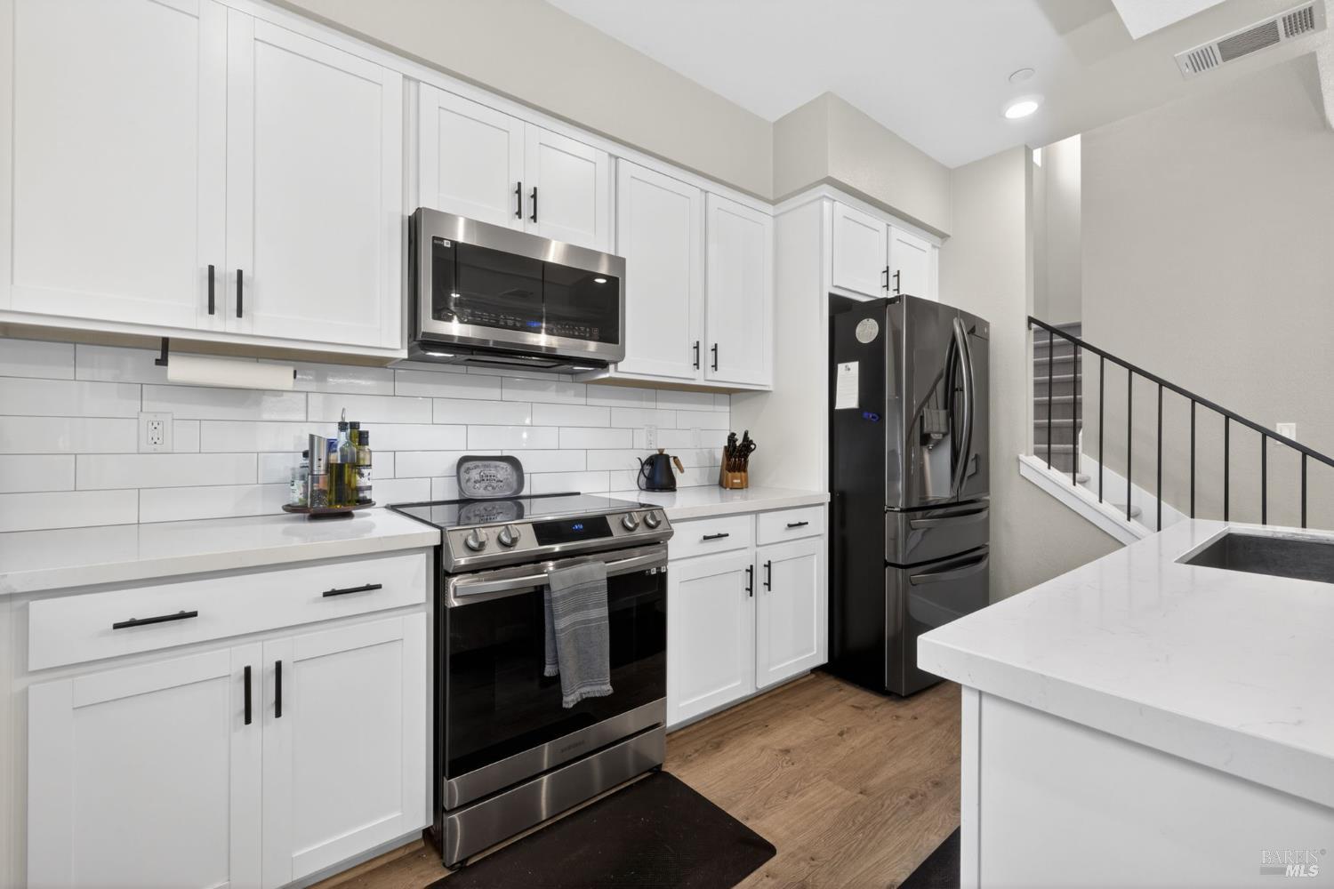 2215-2217 Versaro Drive Santa Rosa, CA 95403 - Photo 8 of 45 a kitchen with stainless steel appliances a stove microwave and refrigerator