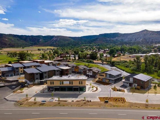 an aerial view of residential houses with outdoor space