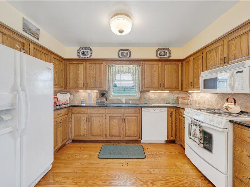 1091 Cool Rock Road Vinton, VA 24179 - Photo 11 of 44 a kitchen with granite countertop a stove top oven sink and cabinets