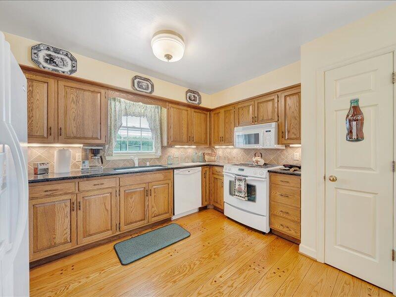 1091 Cool Rock Road Vinton, VA 24179 - Photo 13 of 44 a kitchen with granite countertop a stove top oven sink and cabinets