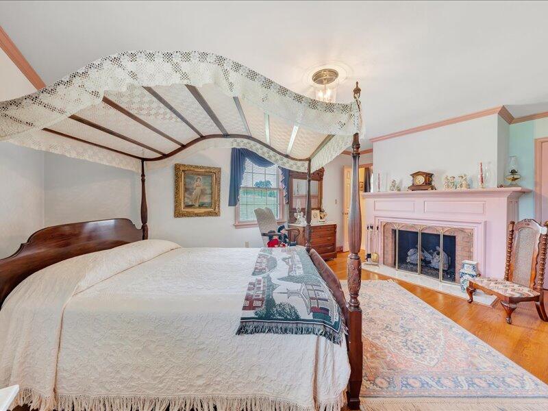 1091 Cool Rock Road Vinton, VA 24179 - Photo 25 of 44 a bed room with a bed and a fireplace