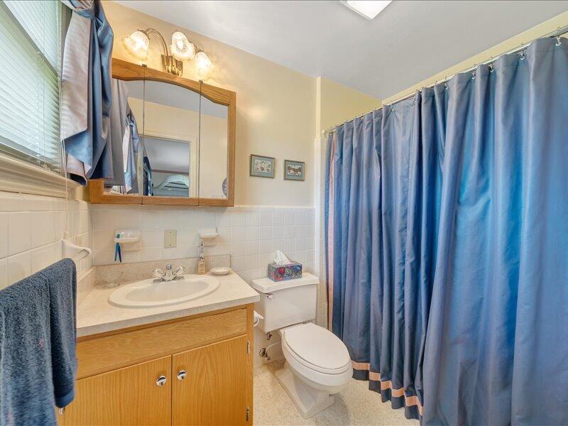 1091 Cool Rock Road Vinton, VA 24179 - Photo 26 of 44 a bathroom with a sink a toilet and mirror